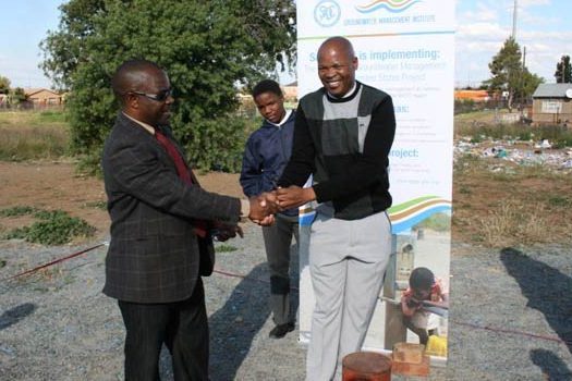 Mr Sauramba Handing over the Borehole key to the school Deputy Principal, Mr Charles Busack